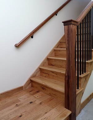 Materials in stock are less expensive &mdash; e.g., red oak is the most common hardwood and among the least expensive.